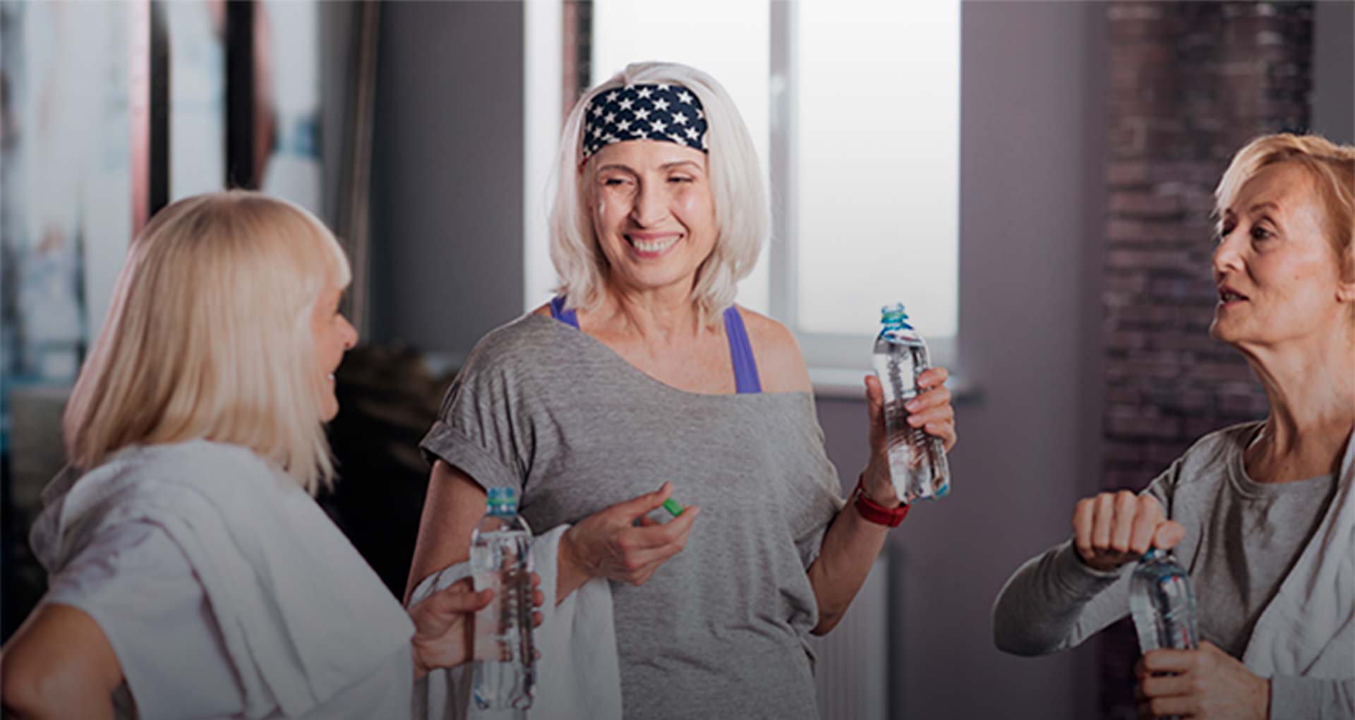 Women drinking water for hydration after exercise