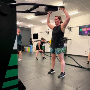 Hitsona female member doing a shoulder press using a HIT Machine